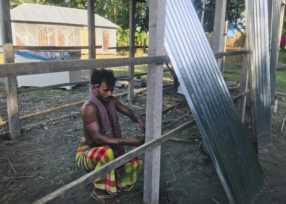 A Bangladeshi man builds a shelter for his family after the flood water inundated his village in Manikganj, some 100 kilometers (62 miles) from Dhaka, Bangladesh, Thursday, Aug. 13, 2020. Across South Asia, more than 17 million people have been affected by this year's monsoon flood. Nearly 700 people have died in Bangladesh, India and Nepal as almost one-third of Bangladesh went under water while Indian states of Assam and Bihar in the northeast were largely affected and vast regions in Nepal were flooded and monsoon-triggered landslides became a nightmare. (AP Photo/Al-emrun Garjon)