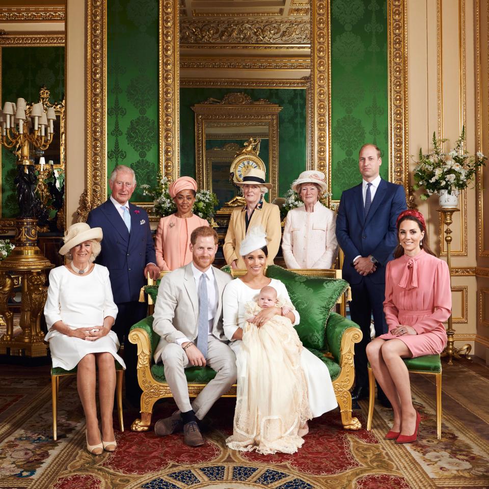 This official handout Christening photograph released by the Duke and Duchess of Sussex shows Britain's Prince Harry, Duke of Sussex (centre left), and his wife Meghan, Duchess of Sussex holding their baby son, Archie Harrison Mountbatten-Windsor flanked by (L-R) Britain's Camilla, Duchess of Cornwall, Britain's Prince Charles, Prince of Wales, Ms Doria Ragland, Lady Jane Fellowes, Lady Sarah McCorquodale, Britain's Prince William, Duke of Cambridge, and Britain's Catherine, Duchess of Cambridge in the Green Drawing Room at Windsor Castle, west of London on July 6, 2019. - Prince Harry and his wife Meghan had their baby son Archie christened on Saturday at a private ceremony. 