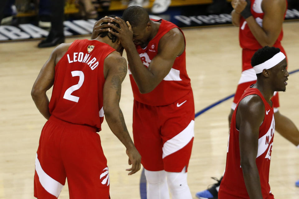 Kawhi Leonard #2 and Serge Ibaka #9 of the Toronto Raptors celebrate late in the game against the Golden State Warriors during Game Six of the 2019 NBA Finals at ORACLE Arena on June 13, 2019 in Oakland, California. (Photo by Lachlan Cunningham/Getty Images)