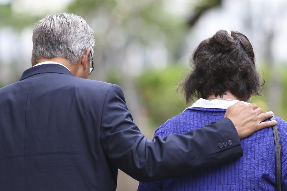 FILE - In this June 25, 2019 file photo, former Honolulu police chief Louis Kealoha, left, and his wife former deputy prosecutor Katherine Kealoha, leave federal court in Honolulu. A jury has found the former Honolulu prosecutor and her now-retired police chief husband guilty in a plot to frame a relative to silence him from revealing fraud that financed their lavish lifestyle. The verdict came Thursday, June 27, 2019, in what has been described as Hawaii’s biggest corruption case. (AP Photo/Caleb Jones, File)