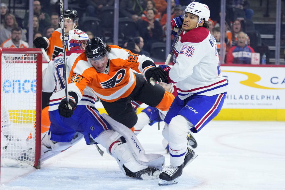 Philadelphia Flyers' Brendan Lemieux (22) collides with Montreal Canadiens' Johnathan Kovacevic (26) and Cayden Primeau (30) during the second period of an NHL hockey game, Tuesday, March 28, 2023, in Philadelphia. (AP Photo/Matt Slocum)