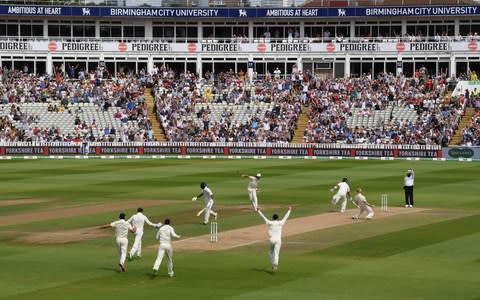 England players and fans celebrate after bowler Ben Stokes had taken the wicket of Virat Kohli - Credit: GETTY IMAGES