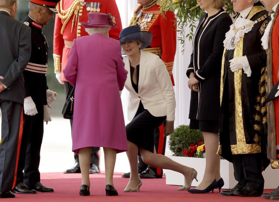 Theresa May performs her best curtsy for the Queen (Getty Images)