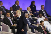 British Prime Minister Boris Johnson reacts as he walks on stage to take his seat during the opening ceremony of the Commonwealth Heads of Government Meeting (CHOGM) on Friday, June 24, 2022 in Kigali, Rwanda. Leaders of Commonwealth nations are meeting in Rwanda Friday in a summit that promises to tackle climate change, tropical diseases and other challenges deepened by the COVID-19 pandemic. (Dan Kitwood/Pool Photo via AP)