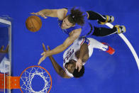 Orlando Magic's Robin Lopez, top, goes up for a shot against Philadelphia 76ers' Joel Embiid during the first half of an NBA basketball game, Wednesday, Jan. 19, 2022, in Philadelphia. (AP Photo/Matt Slocum)