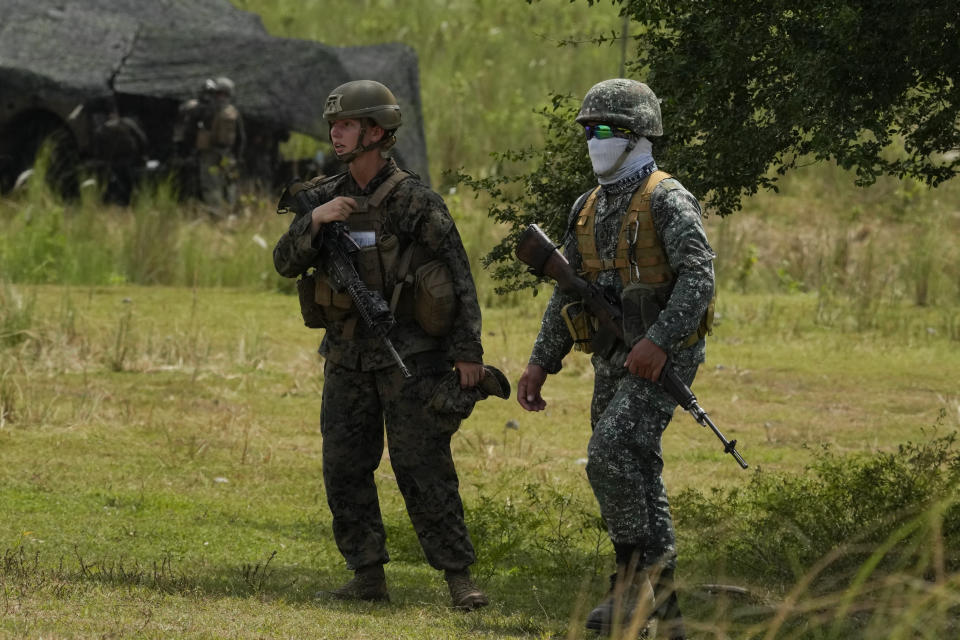 Filipino and American Marines walks during annual combat drills between the Philippine Marine Corps and U.S. Marine Corps in Capas, Tarlac province, northern Philippines, Thursday, Oct. 13, 2022. Truck-mounted launchers blasted off rockets Thursday and U.S. stealth fighter jets streaked across the northern Philippine sky in a combat drill and latest display of American firepower in a region where Washington has tried to deter what it warns as China's growing aggression. (AP Photo/Aaron Favila)