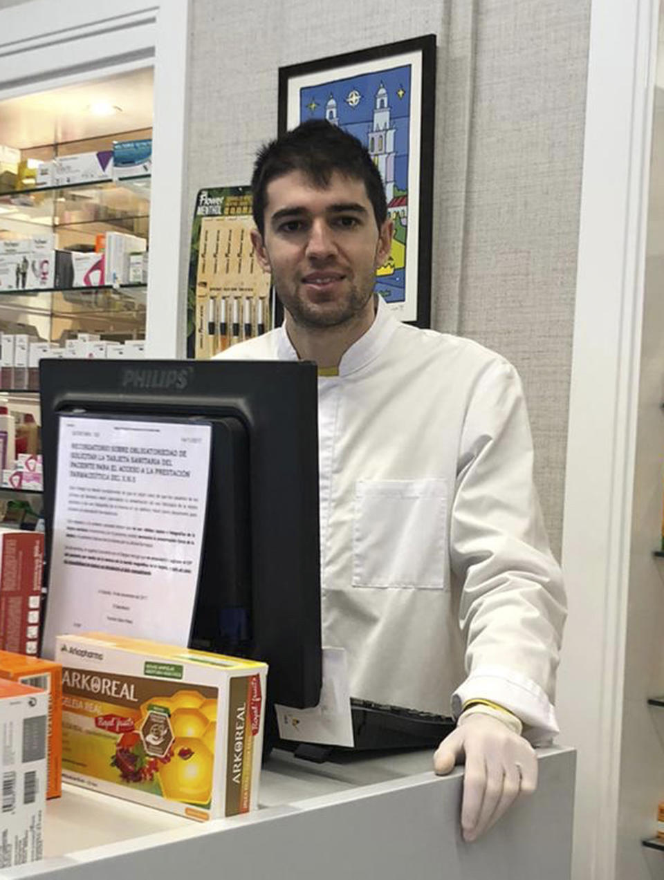 In this photo taken on March 18, 2020, soccer player Toni Dovale poses while working in his family pharmacy in A Coruna, Spain. Dovale, a former Sporting Kansas City and Celta Vigo player who came through Barcelona's famed youth academy, is back at work in his home country while soccer competitions remain on hold because of the COVID-19. Dovale is making calls to try to guarantee there are enough protective masks, gloves and other medical supplies that can help slow the spread of the virus in hard-hit Spain. The COVID-19 coronavirus causes mild or moderate symptoms for most people, but for some, especially older adults and people with existing health problems, it can cause more severe illness or death. (Photo via AP)