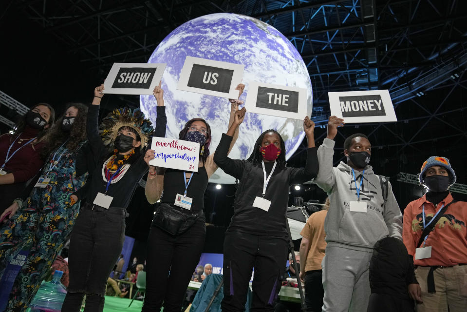 Climate activist Vanessa Nakate, third right, and other activists engage in a 'Show US The Money' protest at the COP26 U.N. Climate Summit in Glasgow, Scotland, Monday, Nov. 8, 2021. The U.N. climate summit in Glasgow gathers leaders from around the world, in Scotland's biggest city, to lay out their vision for addressing the common challenge of global warming. (AP Photo/Alastair Grant)