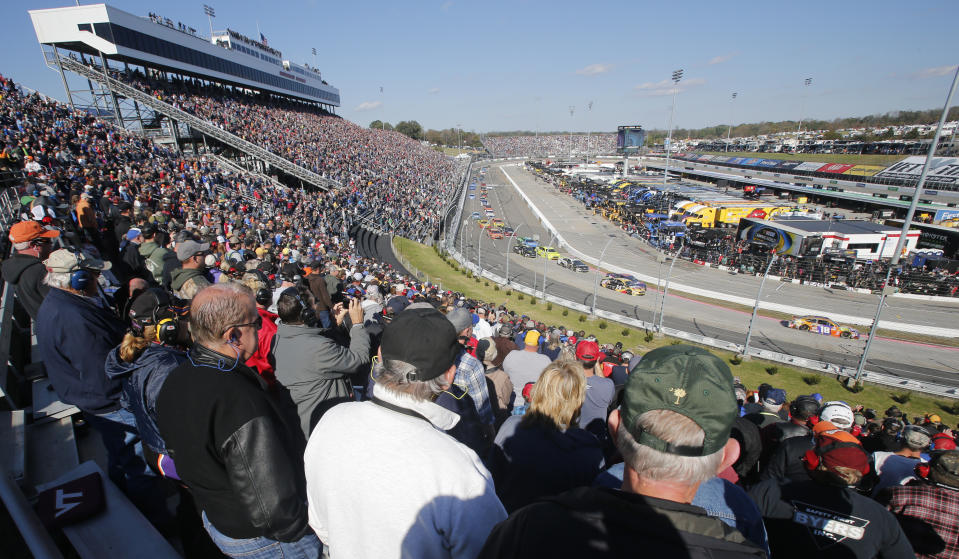 Race fans watch the start of the Monster Energy NASCAR Cup Series auto race at Martinsville Speedway in Martinsville, Va., Sunday, Oct. 28, 2018. (AP Photo/Steve Helber)