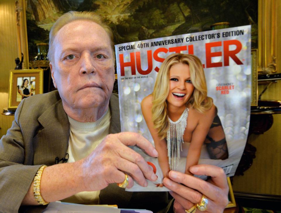 Porn mogul Larry Flynt poses with an issue of Hustler magazine as he talks about the 40th anniversary of the magazine on (FILES) In this file photo taken on Aug. 26, 2014, in Beverly Hill.