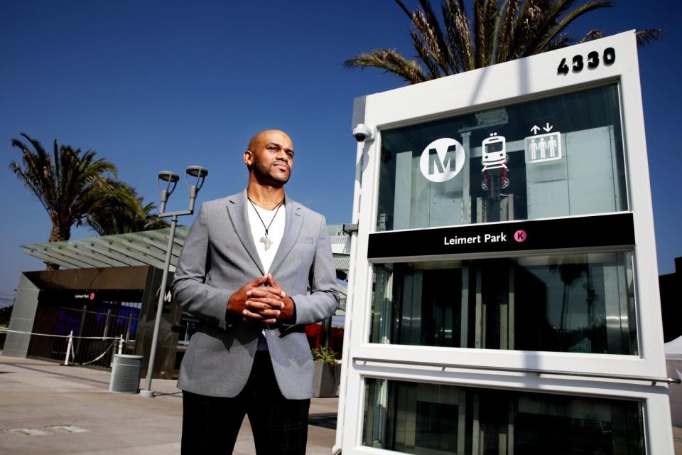 A man stands next to a Metro stop