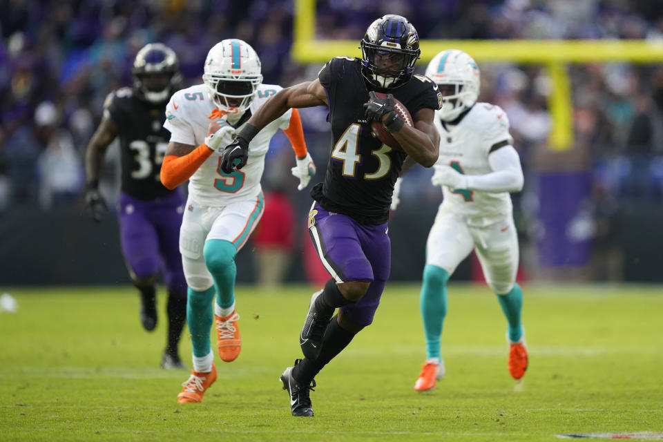 Baltimore Ravens running back Justice Hill (43) runs for a long gain past Miami Dolphins cornerback Jalen Ramsey (5) during the second half of an NFL football game in Baltimore, Sunday, Dec. 31, 2023. (AP Photo/Matt Rourke)