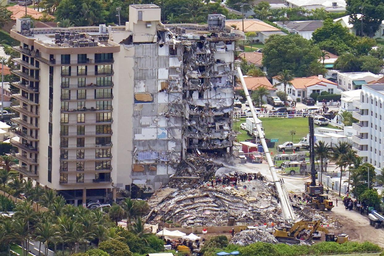 Workers search in the rubble at the Champlain Towers South Condo, Saturday, June 26, 2021, in Surfside, Fla. 159 people were still unaccounted for two days after Thursday's collapse, which killed at least four.