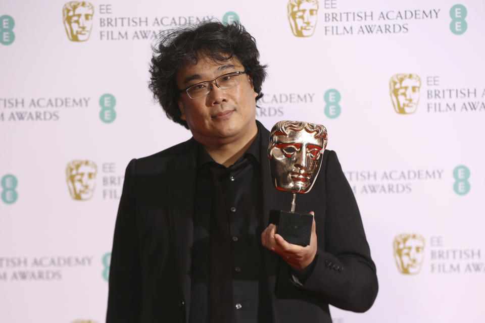 Director Bong Joon-ho holds the Best Foreign Language Bafta Award for the film Parasite, backstage at the Bafta Film Awards, in central London, Sunday, Feb. 2, 2020. (Photo by Joel C Ryan/Invision/AP)