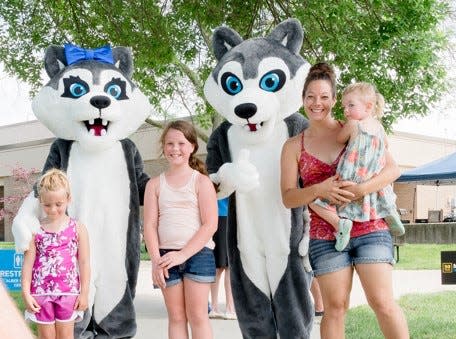 Marion Tech’s mascots, Veda (which means knowledge) and Enzo (which means home leader) stand with attendees at the Big Tent Event. The huskies were chosen as mascots because they are leaders, as are Marion Tech students and graduates.