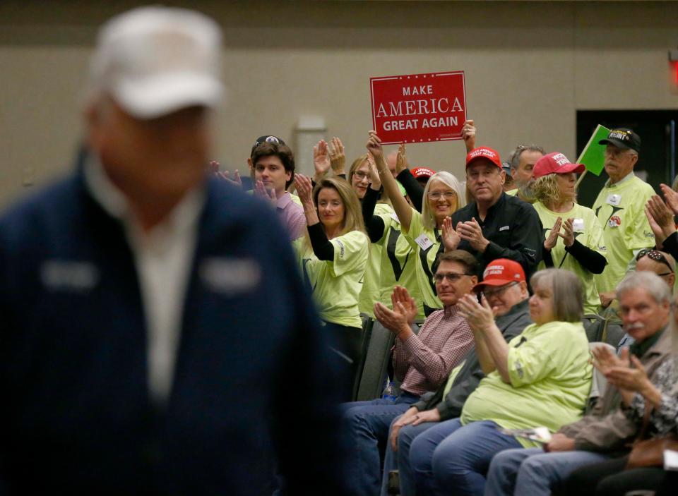 Trump supporters express their support after former congressman Billy Long, left, speaks about his friendship with the former president during the Greene County Republican Caucus at the Oasis Convention Center in north Springfield on March 2, 2024.