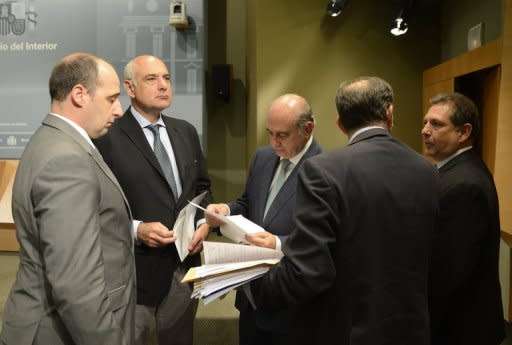 Spanish Mininster of Interior Jorge Fernandez Diaz (third left) speaks with his staff after a press conference in Madrid, on August 2. Spanish police arrested three suspected members of Al-Qaeda who had enough explosives to blow up a bus and were thought to be planning an attack in Spain or elsewhere in Europe, the government said Thursday