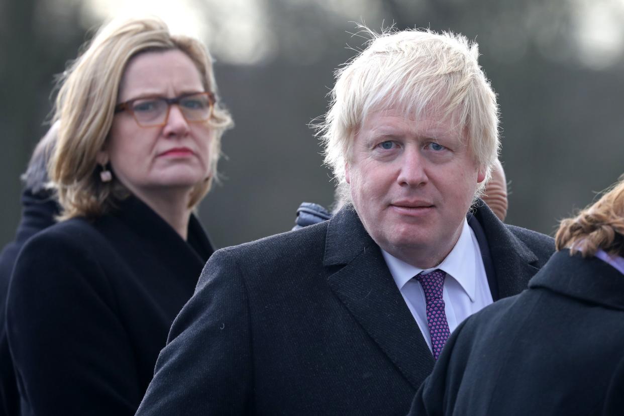 Britain's Foreign Secretary Boris Johnson (R) and Britain's Home Secretary Amber Rudd (L) attend a ceremony at the Royal Military Academy Sandhurst, west of London on January 18, 2018. French President Emmanuel Macron will take part in a Franco-British summit to discuss migration and Brexit. / AFP PHOTO / Ludovic MARIN        (Photo credit should read LUDOVIC MARIN/AFP via Getty Images)