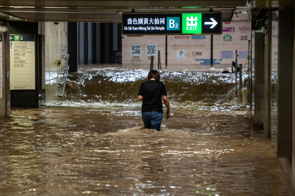 A women walking in a flooded MTR train station during a rainstorm on September 8, 2023 in Hong Kong, China. The Hong Kong Observatory issued a black rainstorm alert on September 7th, marking the first one in 2 years. The sudden downpours triggered flash flooding across the city, including the residential area of Wong Tai Sin, where vehicles were stranded on a highway amidst heavy rain. (Photo by Vernon Yuen/NurPhoto via Getty Images)