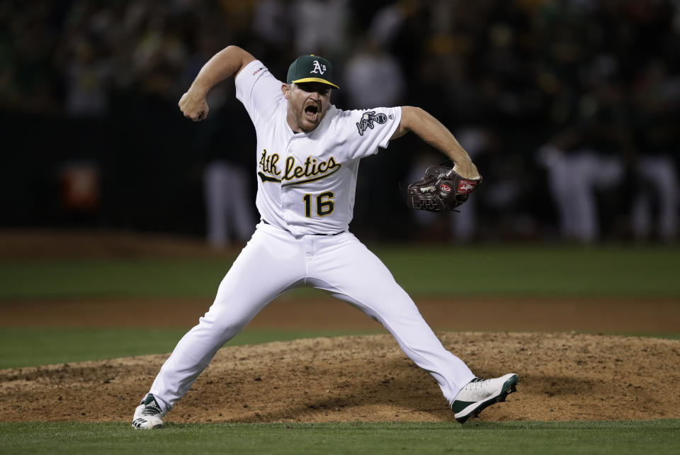 FILE - In this Aug. 21, 2019, file photo, Oakland Athletics pitcher Liam Hendriks celebrates as the final out is made in the team's baseball game against the New York Yankees, in Oakland, Calif. Manager Bob Melvin and the Oakland Athletics have put their faith in Hendriks to finish games as a reliable ninth-inning option night after night. Never one to stick with traditional methods and frustrated with himself last year in Triple-A, Hendriks searched for a way to transform his mental approach. This good-natured Aussie was in need of an attitude shift. And an energy healer named Rubi Rios sure provided a nice assist in his transformation process. (AP Photo/Ben Margot, File)