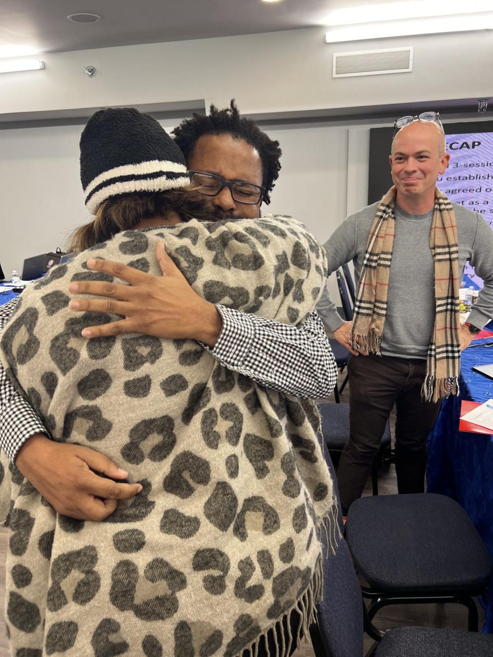 Frank Johnson and Stephanie Love embrace at the board retreat in November.