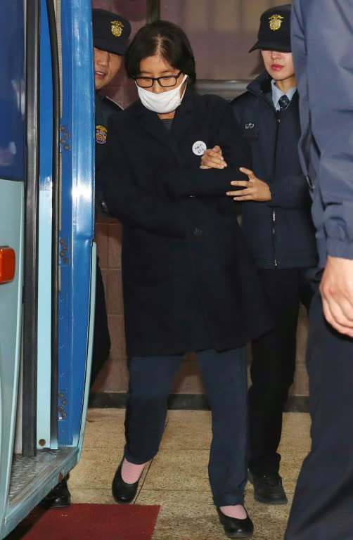 Choi Soon-Sil (C), the woman at the heart of the political scandal engulfing South Korea's President Park Geun-Hye, is escorted out of the Seoul Central District Prosecutors' Office