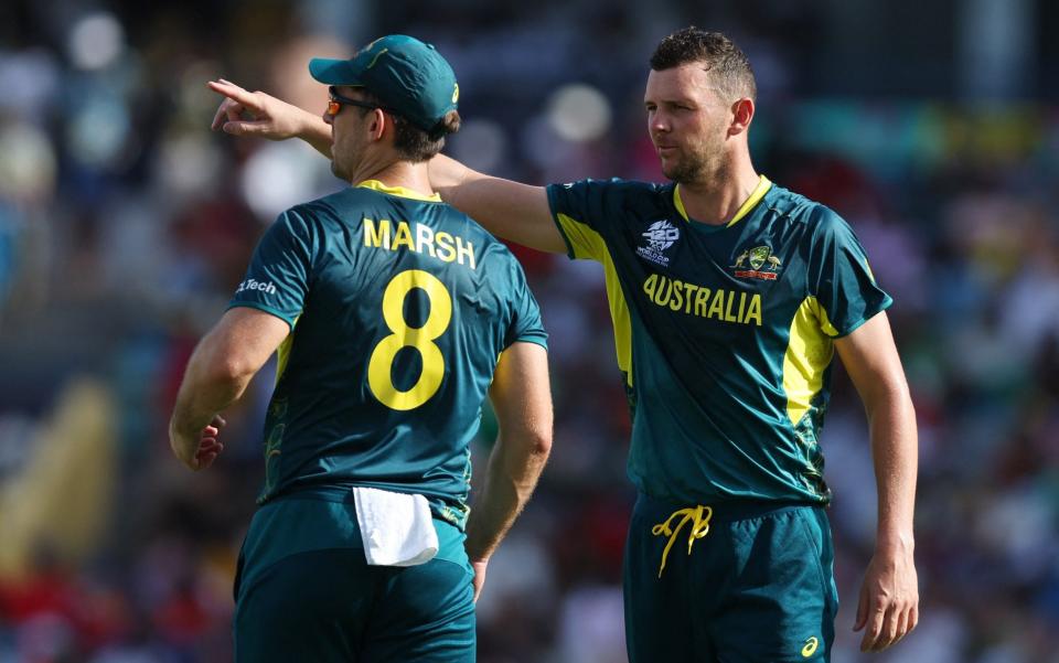 Australia's Josh Hazlewood and Mitchell Marsh talks during play