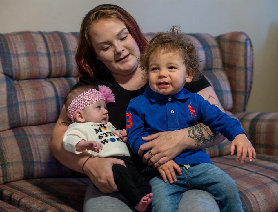 Patricia, center, holds her daughter, Annalyce, left, 3 months, and her son, Noah, 15 months, at their home in Bristol Township, on Friday Nov. 18, 2022.