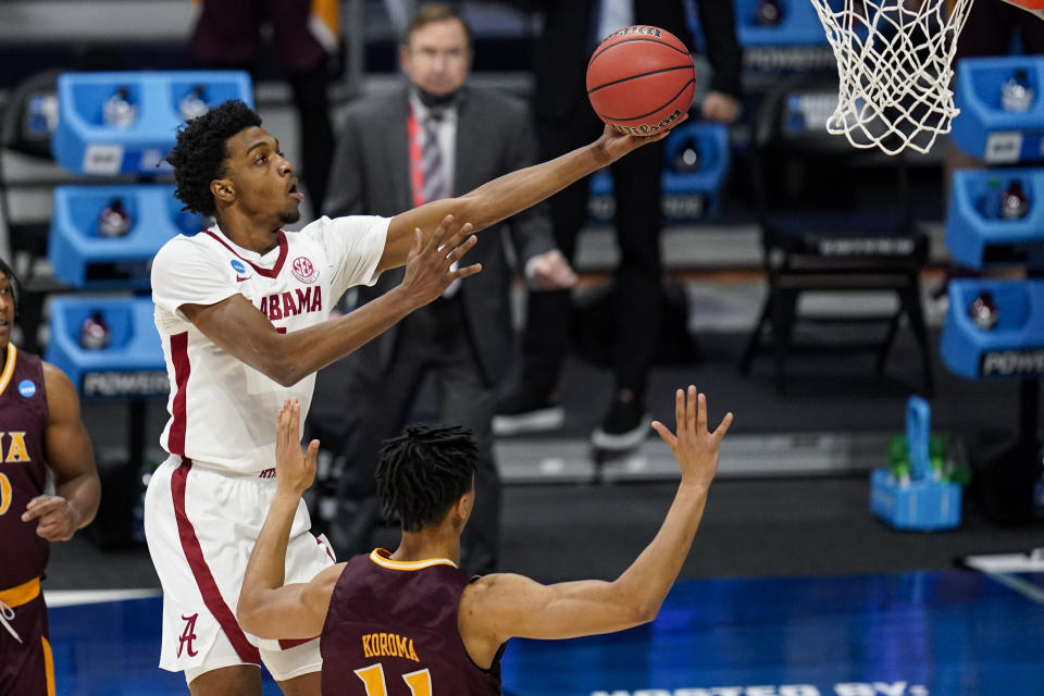 Alabama forward Herbert Jones (1) shoots over Iona forward Dwayne Koroma (11) in the first half of a first-round game in the NCAA men's college basketball tournament at Hinkle Fieldhouse in Indianapolis, Saturday, March 20, 2021. (AP Photo/Michael Conroy)