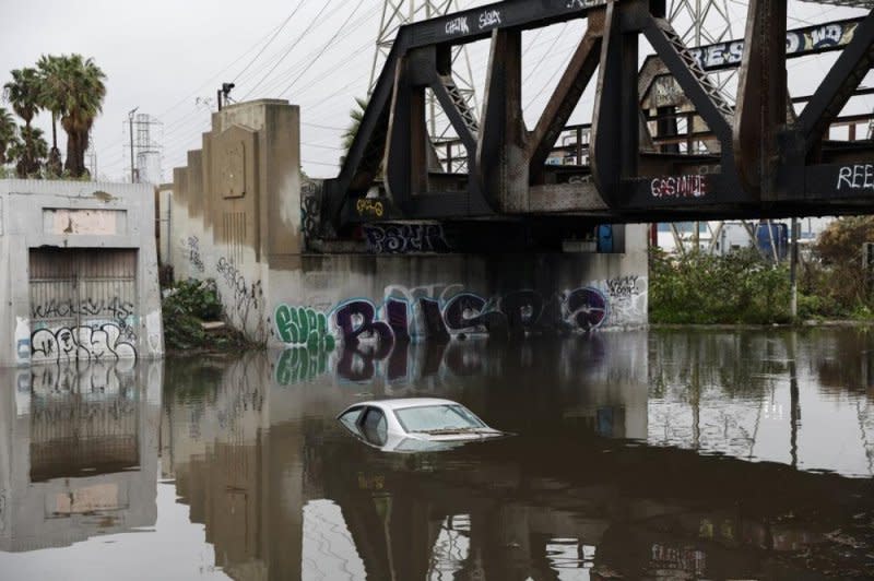A car is submerged after rain from an atmospheric river storm hit hours earlier in Long Beach, Calif., on Thursday. The storm continued to hammer southern California on Monday. Photo by Caroline Brehman/EPA-EFE