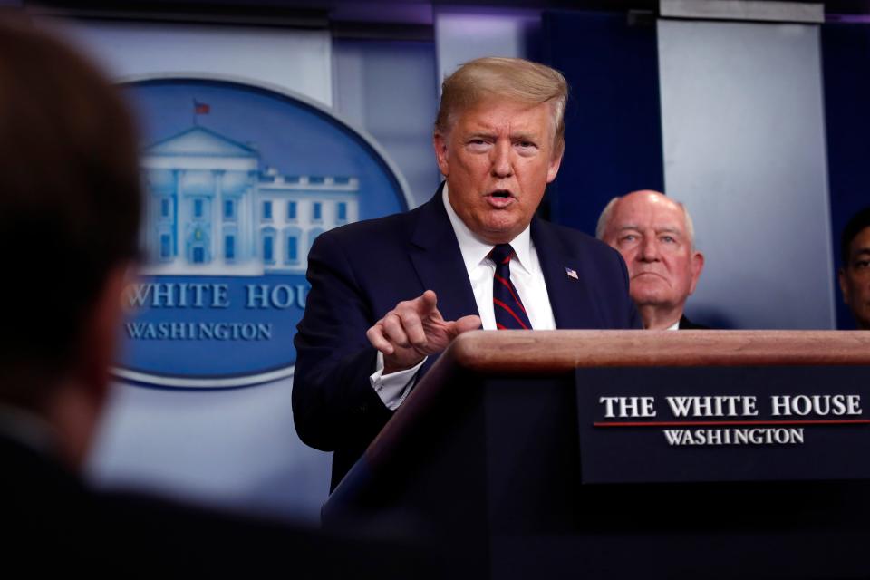 President Donald Trump speaks about the coronavirus in the James Brady Press Briefing Room, Friday, March 27, 2020, in Washington as Agriculture Secretary Sonny Perdue listens.