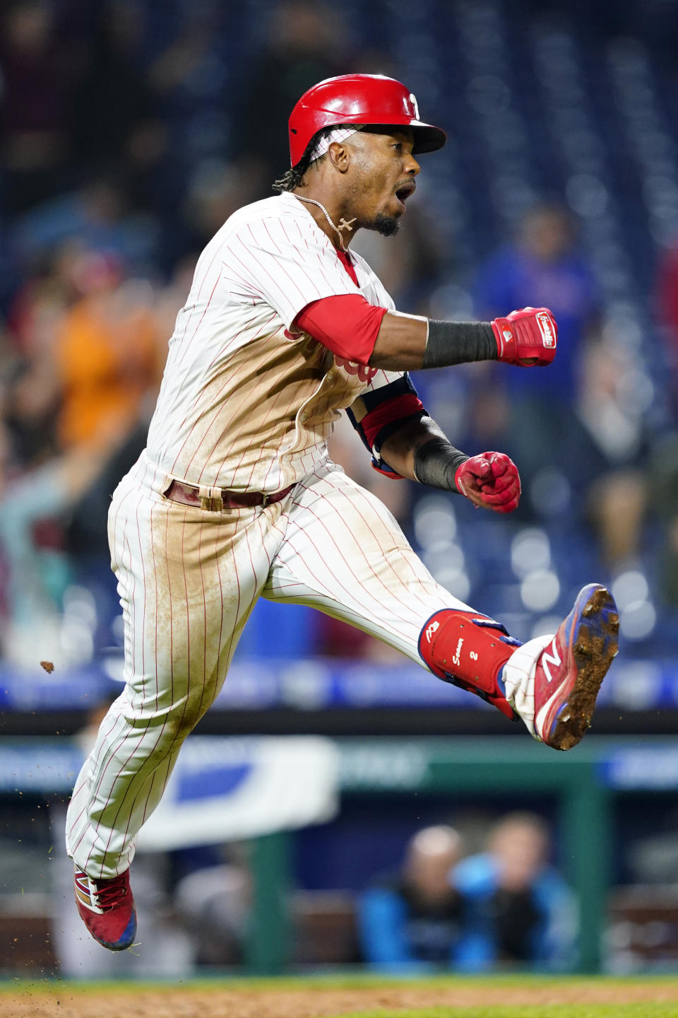 Philadelphia Phillies' Jean Segura celebrates after hitting a game-winning RBI-single against Miami Marlins pitcher Tommy Nance during the ninth inning of a baseball game, Tuesday, Sept. 6, 2022, in Philadelphia. (AP Photo/Matt Slocum)