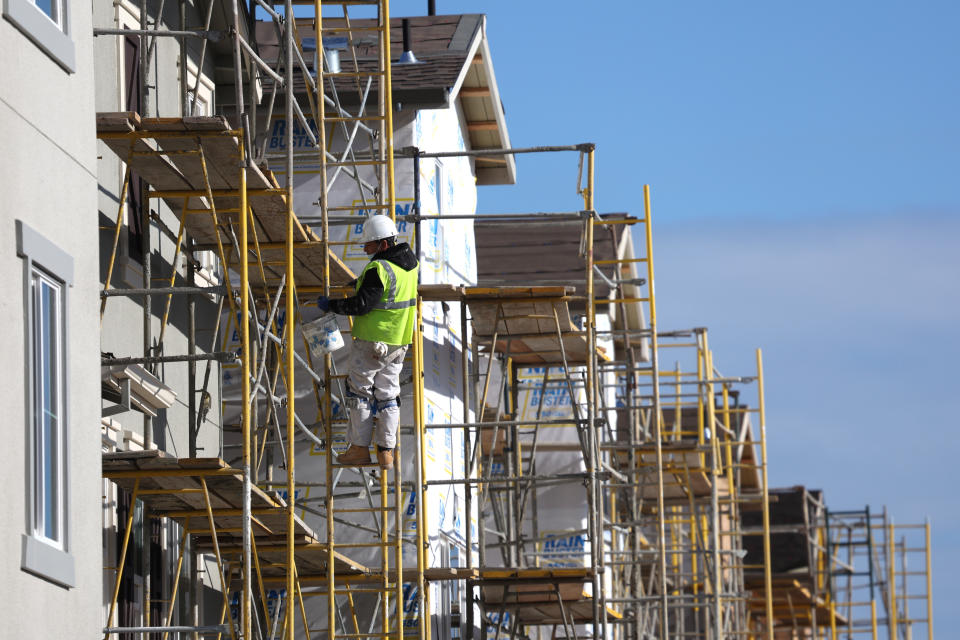 NEWARK, CALIFORNIA - DECEMBER 15: A worker makes repairs to a home under construction at the Lennar Bridgeway home development on December 15, 2021 in Newark, California. Homebuilder Lennar will report fourth quarter earnings today after the closing bell. (Photo by Justin Sullivan/Getty Images)