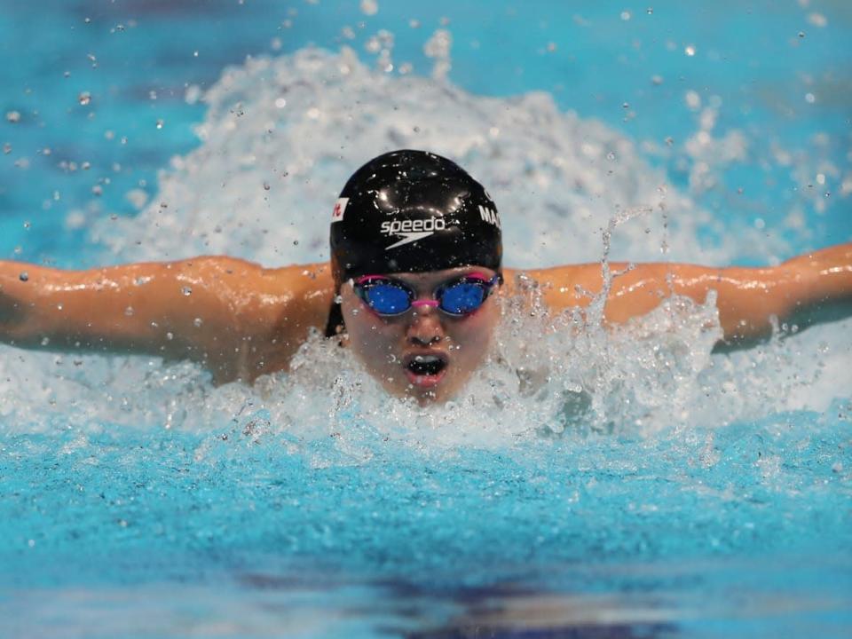 Canadian Maggie Mac Neil swims to victory in the women&#39;s 100-metre butterfly on the final day of the FINA short-course world championships in Abu Dhabi, United Arab Emirates on Tuesday. (Kamran Jebreili/The Associated Press - image credit)