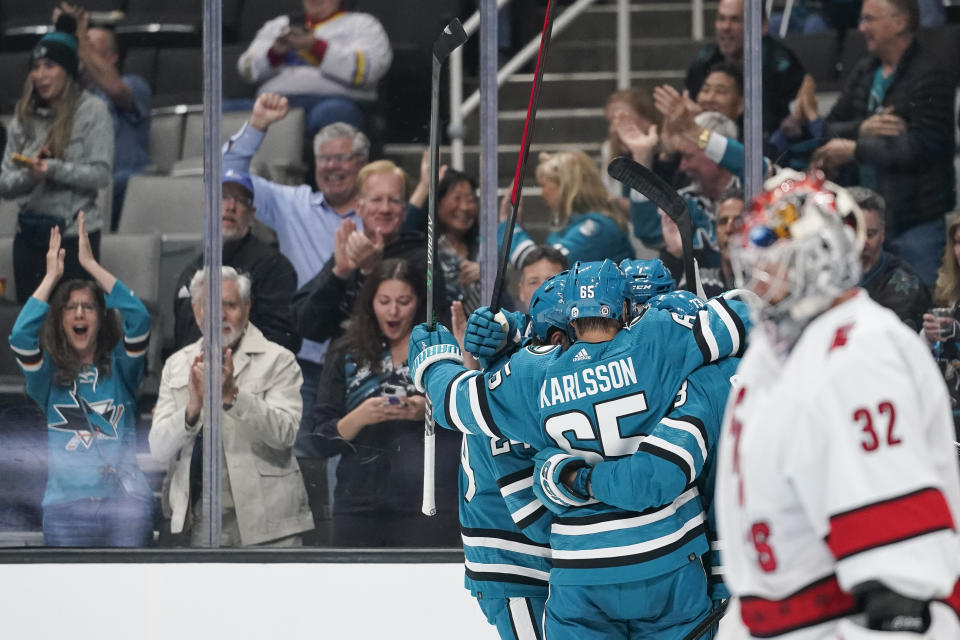 San Jose Sharks celebrate after Evgeny Svechnikov scored against the Carolina Hurricanes during the first period of an NHL hockey game in San Jose, Calif., Friday, Oct. 14, 2022. (AP Photo/Godofredo A. Vásquez)