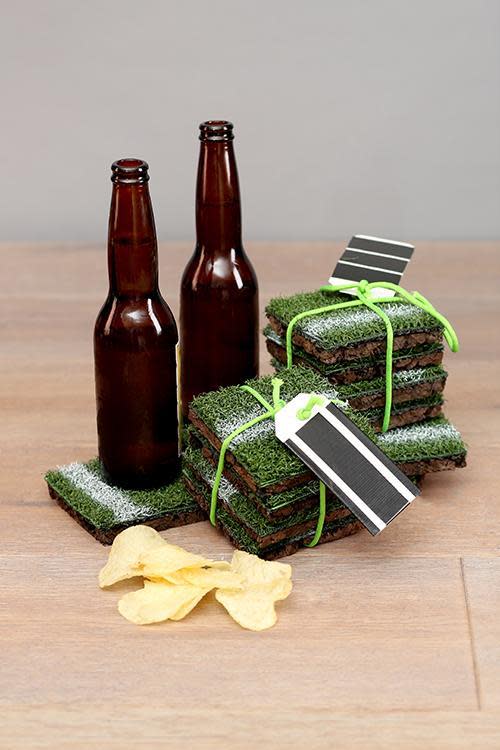 completed diy astro turf coasters wrapped, pictured with beer bottles