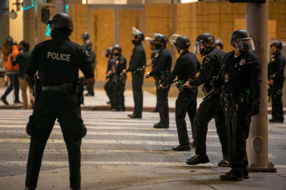 LAPD officers follow protesters in Los Angeles on April 15, 2021.  / Credit: Francine Orr / Los Angeles Times via Getty