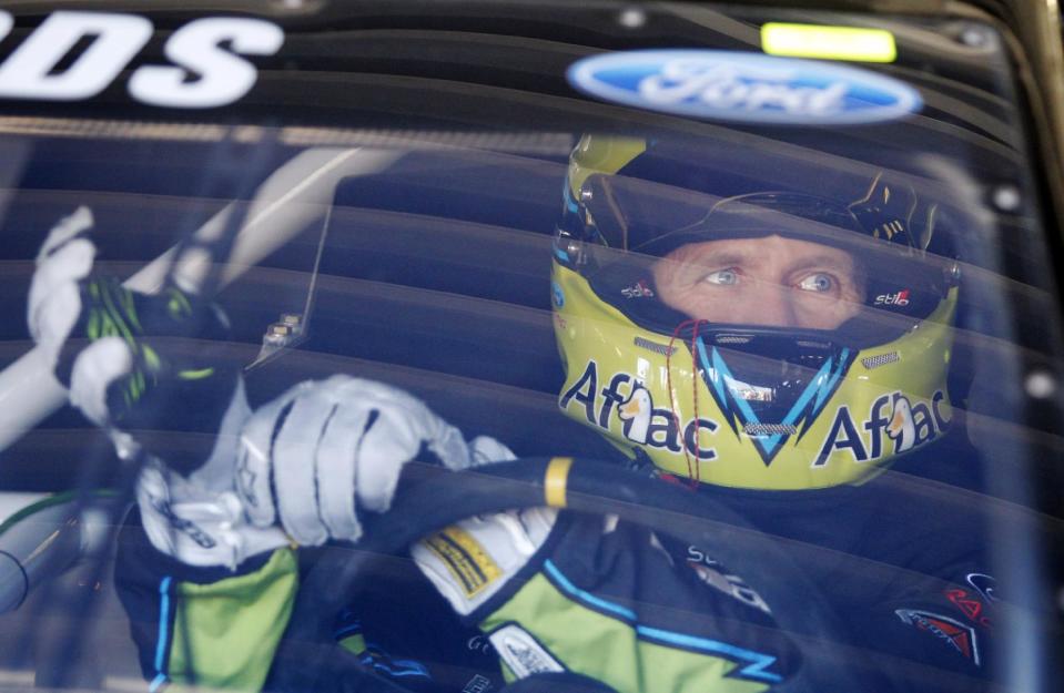 Driver Carl Edwards adjusts his gloves before practice, Friday, May 9, 2014, at Kansas Speedway in Kansas City, Kan., for Saturday night's NASCAR Sprint Cup series auto race. (AP Photo/Colin E. Braley)