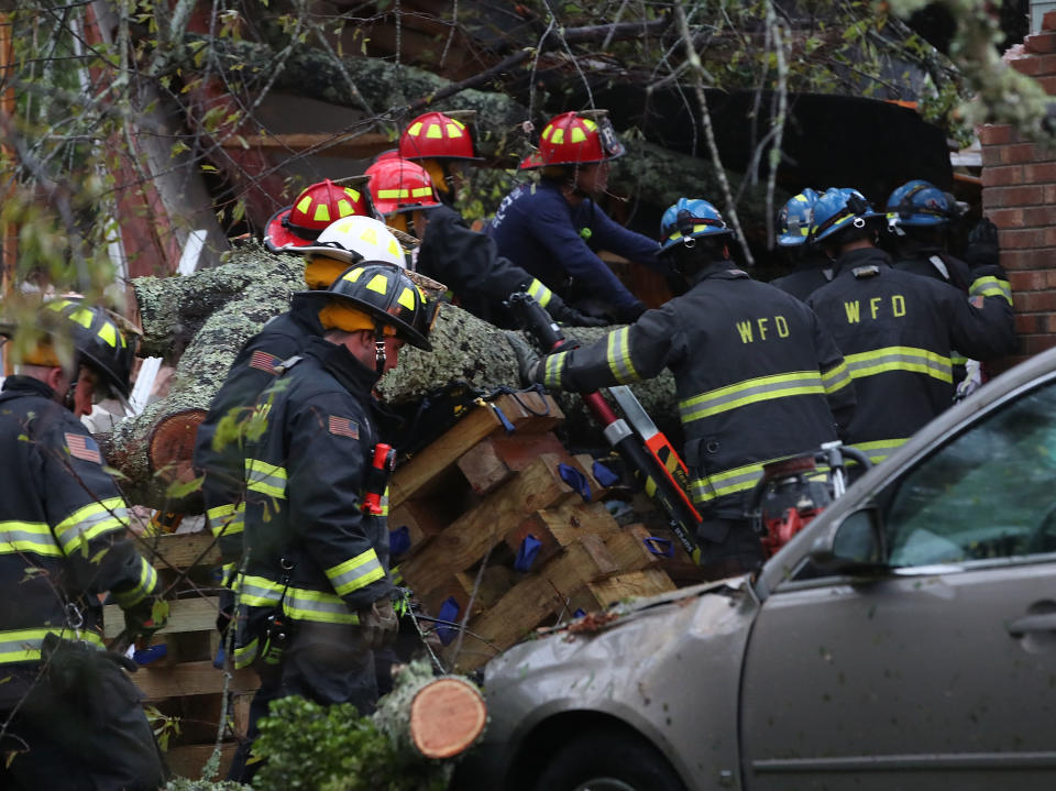 Firefighters try desperately to free the family trapped inside their Wilmington home. Source: Getty