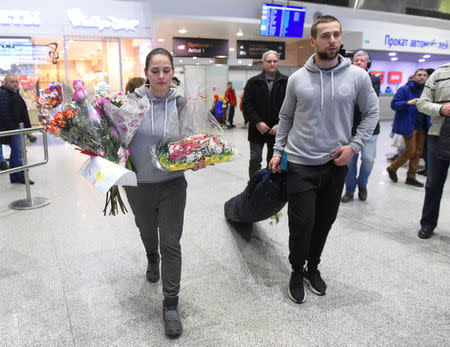 Russian Olympic curlers Alexander Krushelnitsky and his wife Anastasia Bryzgalova return from the Pyeongchang 2018 Winter Olympics, at Pulkovo airport outside St. Petersburg, Russia February 22, 2018. REUTERS/Sergei Nikolaev