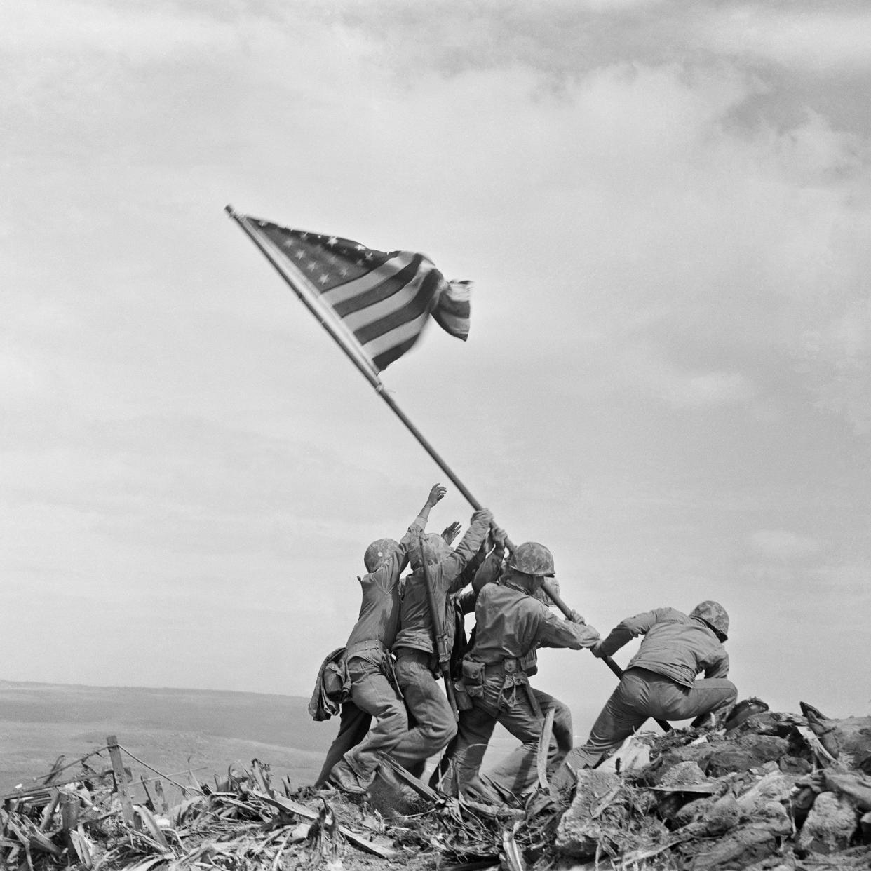 US Marines raise the Stars and Stripes over Iwo Jima in 1945