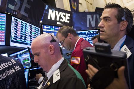 Traders work on the floor of the New York Stock Exchange August 12, 2014. REUTERS/Brendan McDermid