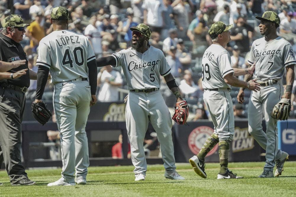 Umpires, left, call for calm while Chicago White Sox third base coach Joe McEwing (99), second from right, holds back White Sox shortstop Tim Anderson (7) during a baseball game against the New York Yankees, Saturday, May 21, 2022, in New York. (AP Photo/Bebeto Matthews)