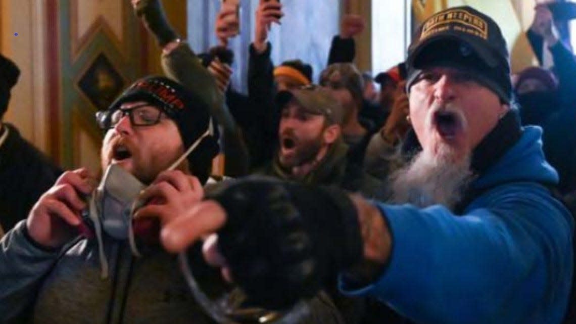Indiana resident Jon Schaffer, right, is shown inside the U.S. Capitol Building during the Jan. 6, 2021, rioting, according to the FBI. He pleaded guilty to two felonies Friday and agreed to help the government's case.