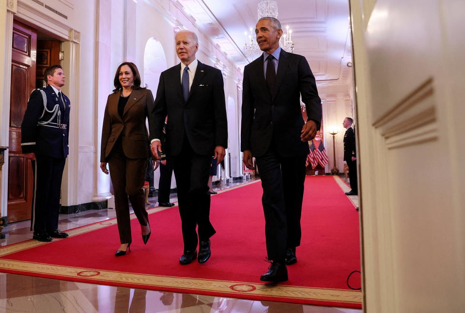 U.S. President Joe Biden is flanked by Vice President Kamala Harris and former President Barack Obama as he arrives to deliver remarks on the Affordable Care Act and Medicaid, in the East Room at the White House in Washington, U.S., April 5, 2022. / Credit: LEAH MILLIS / REUTERS