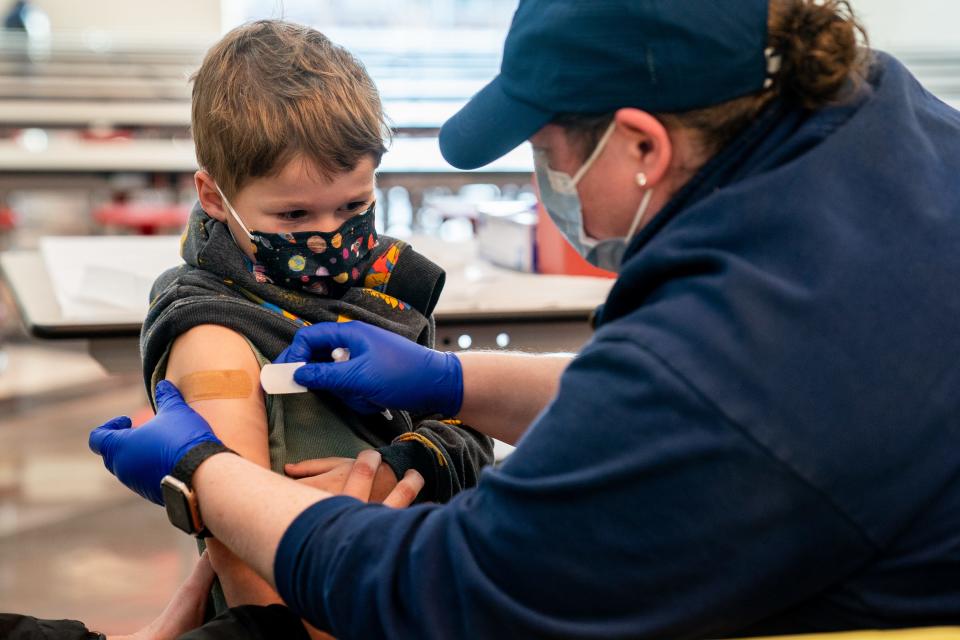 Max Vaatstra, 5, gets a bandaid after receiving a COVID-19 vaccine from Claire Porter, RN, during a vaccination event at John Overton High School in Nashville, Tenn., Monday, Dec. 6, 2021.