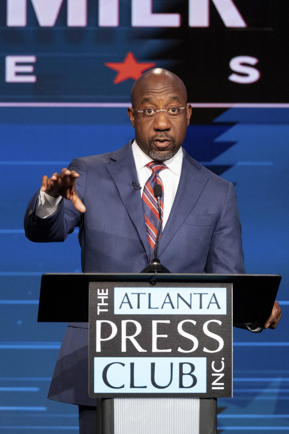 Sen. Raphael Warnock, D-Ga., speaks during a U.S. Senate debate with Libertarian challenger Chase Oliver during the Atlanta Press Club Loudermilk-Young Debate Series in Atlanta on Sunday, Oct. 16, 2022. Republican challenger Herschel Walker was invited but did not attend. (AP Photo/Ben Gray)