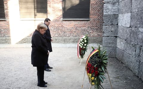 Mandatory Credit: Photo by LUKASZ GAGULSKI/EPA-EFE/REX (10493310p) German Chancellor Angela Merkel (L) and Polish Prime Minister Mateusz Morawiecki (R) lay a wreath at the Death Wall during a visit to the Auschwitz-Birkenau Memorial and Museum of former Nazi German concentration and extermination camp in Oswiecim, Poland, 06 December 2019. Polish Prime Minister Mateusz Morawiecki and German Chancellor Angela Merkel will visit the Memorial ahead of 75th anniversary of the death camp's liberation. German Chancellor ANgela Merkel in former Nazi German concentration camp Auschwitz, Oswiecim, Poland - 06 Dec 2019 - Credit: LUKASZ GAGULSKI/EPA-EFE/REX