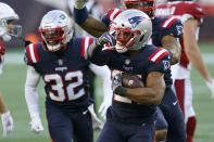New England Patriots defensive back Adrian Phillips, center, celebrates his interception of a pass by Arizona Cardinals quarterback Kyler Murray in the second half of an NFL football game, Sunday, Nov. 29, 2020, in Foxborough, Mass. (AP Photo/Elise Amendola)