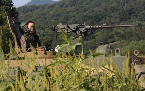 A South Korean army soldier mans a K-9 self-propelled howitzer as he prepares for a military exercise in Paju - Credit: Ahn Young-joon/AP